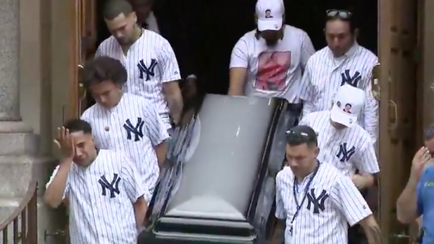 Pallbearers wearing matching New York Yankees jersey carry the casket of 15-year-old Lesandro Junior Guzman-Feliz on Wednesday