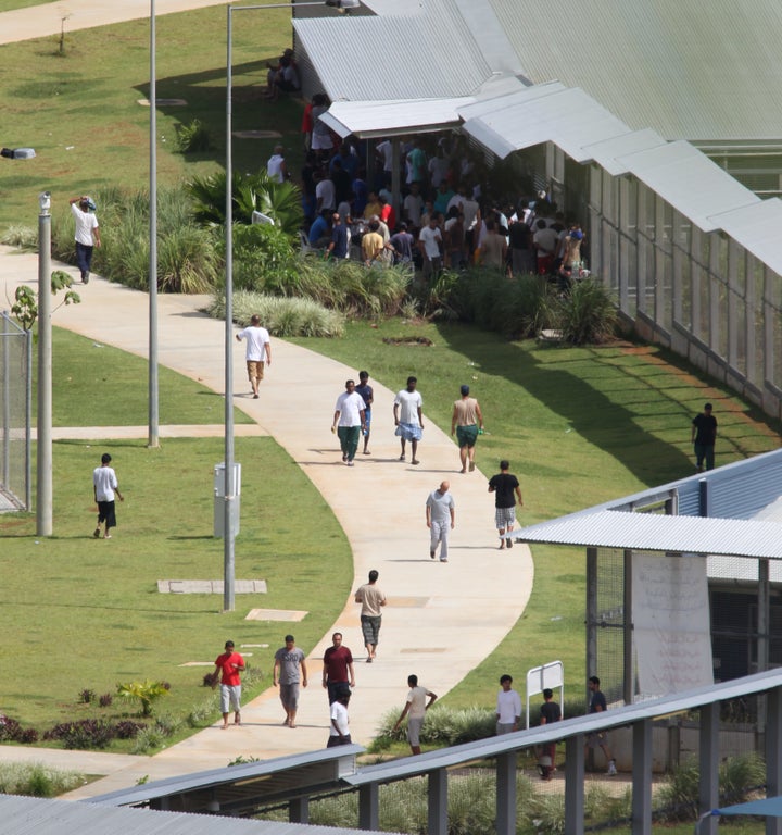 Asylum-seekers walking around inside the detention center compound on Christmas Island.