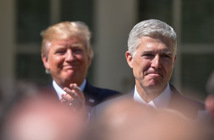 The Koch network spent millions supporting the nomination of Neil Gorsuch (right), seen here with President Donald Trump following Gorsuch's swearing-in ceremony on April 10.