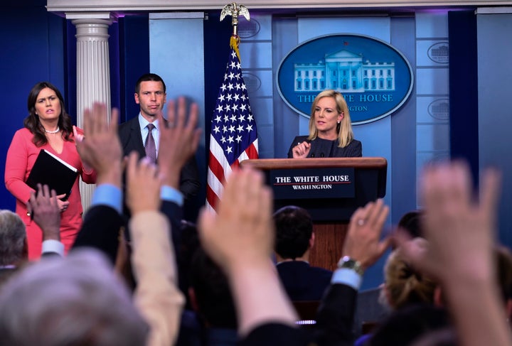 Secretary of Homeland Security Kirstjen Nielsen takes questions while White House press secretary Sarah Huckabee Sanders stands nearby.
