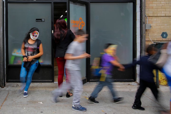 Children with masks exit the Cayuga Centers branch on June 22 in Harlem, New York. The youngest migrant at Cayuga is 9 months old.