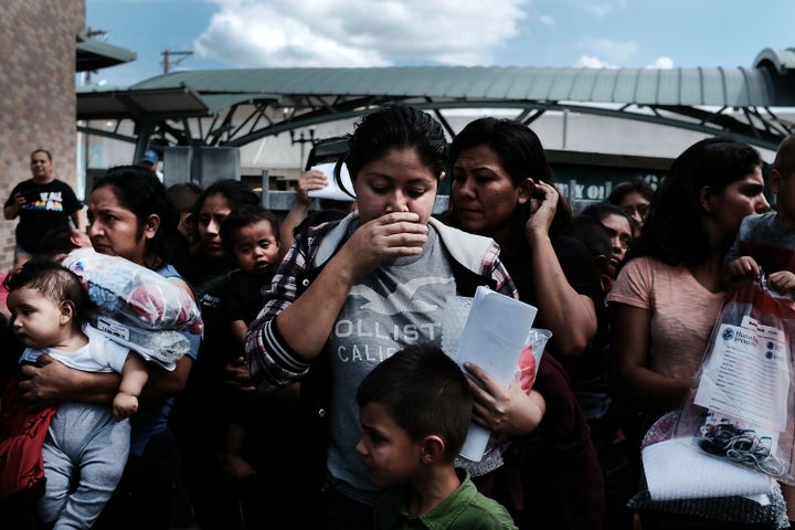 Dozens of women and children, many fleeing poverty and violence in Honduras, Guatemala and El Salvador, arrive at a bus station after being released from Customs and Border Protection on June 22, 2018, in McAllen, Texas.