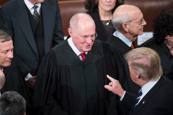 President Donald Trump greets Supreme Court Justice Anthony Kennedy after addressing a joint session of Congress in the Capit