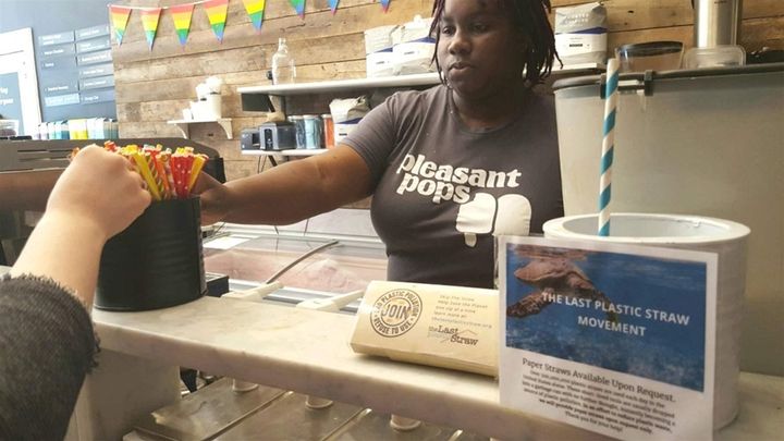 Nadia Bartholomew, a worker at Pleasant Pops coffee and treats shop in Washington, D.C., offers a customer a selection of paper straws. Pleasant Pops has joined the “Last Plastic Straw” movement, a growing number of restaurants no longer using plastic straws, which environmentalists say are hazardous to oceans and sea creatures. States and cities are being asked to ban straws, too. 