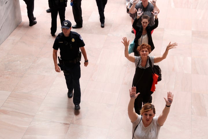 Sarandon walks to be arrested as she joined demonstrators in an anti-Trump immigration policy protest on June 28, 2018. 