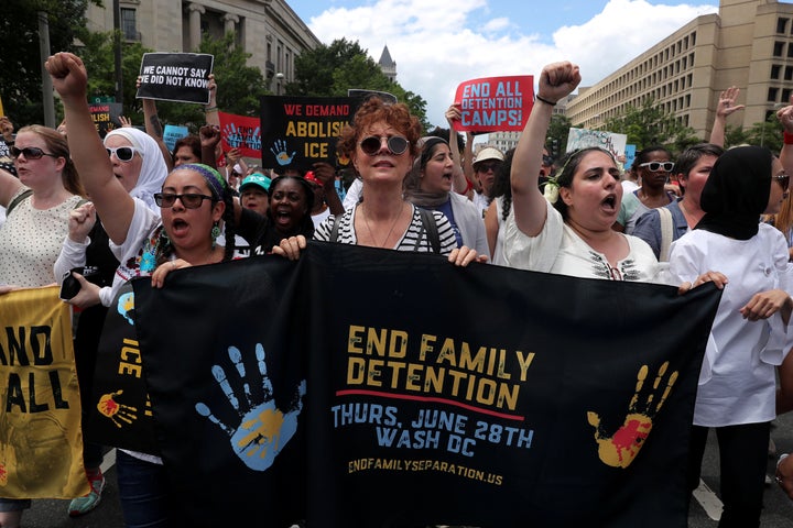 Sarandon holds a banner as immigration activists rally on June 28, 2018.