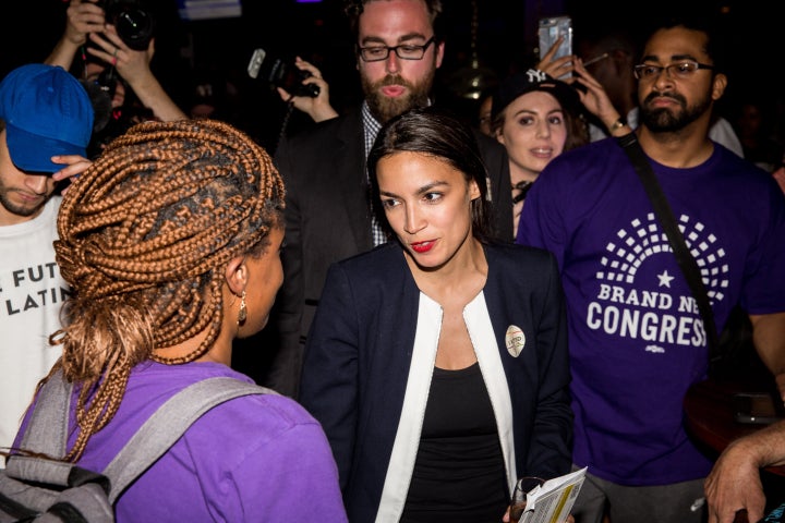 Progressive challenger Alexandria Ocasio-Cortez, center, celebrates with supporters at a victory party in the Bronx in New York City after upsetting Rep. Joseph Crowley in a Democratic primary on June 26, 2018.