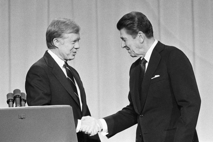 President Jimmy Carter and his Republican challenger, Ronald Reagan, shake hands before their presidential debate in 1980.