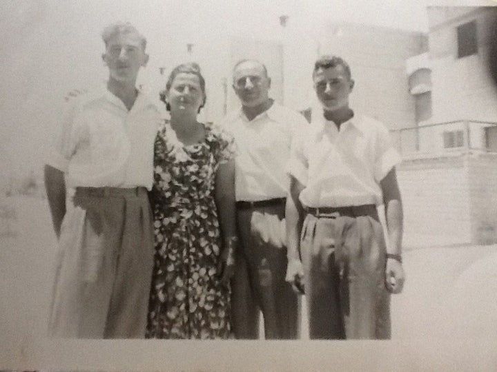 Mordechai, left, as a teen in Israel with his parents and younger brother.