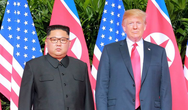 North Korean leader Kim Jong Un poses with U.S. President Donald Trump in Singapore on June 12, 2018.