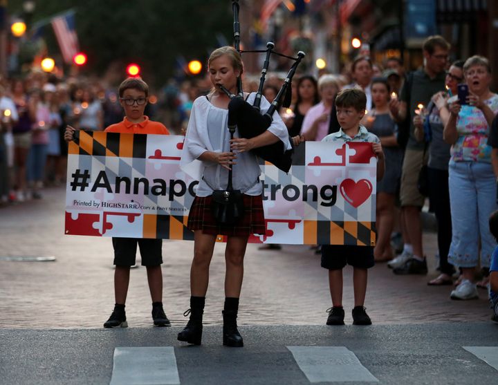 Bagpiper plays "Amazing Grace" at Annapolis march and vigil for victims of the shooting Thursday at the Capital Gazette.