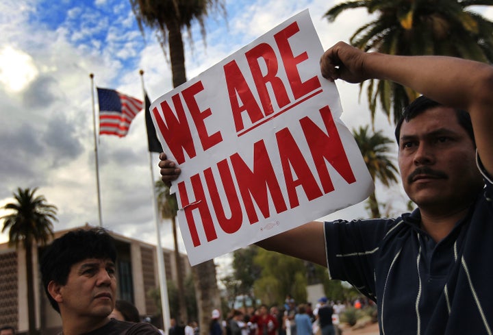 Demonstrators protest Arizona's new immigration law outside the Arizona state capitol building on April 23, 2010 in Phoenix, Arizona.