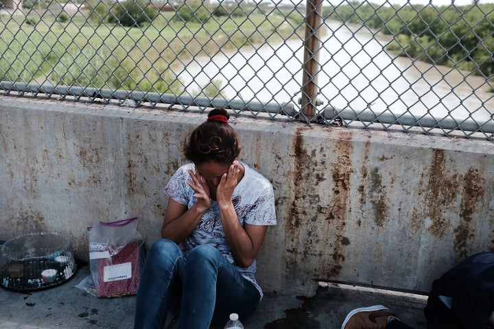 A Honduran woman, fleeing poverty and violence in her home country, waits along the border bridge after being denied entry into the U.S. from Mexico on June 25 at the Brownsville, Texas, crossing.