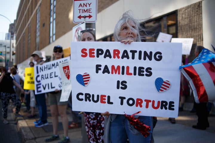 A protester holding a placard during the protest. Protesters participate in a rally organized by Families Belong Together, sp