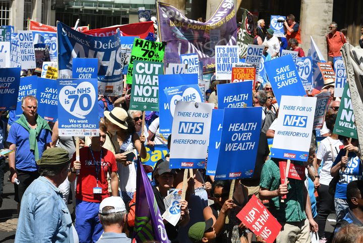 People march in central London to mark the 70th anniversary of the NHS.