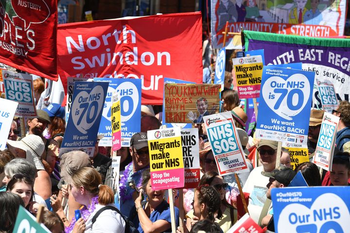 People march in central London to mark the 70th anniversary of the NHS.