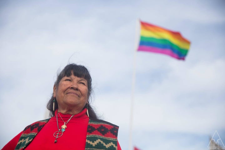 Beverly Little Thunder standing by two-spirit flag at Standing Rock #NoDAPL resistance camp.