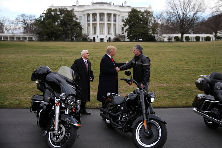 U.S. President Donald Trump shakes hands with Matthew S Levatich, CEO of Harley Davidson, accompanied by Vice President Mike Pence, during a visit of the company's executives at the White House in Washington U.S., February 2, 2017. REUTERS/Carlos Barria