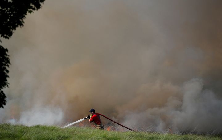A firefighter tackles a moorland fire at Winter Hill, near Rivington, on Sunday