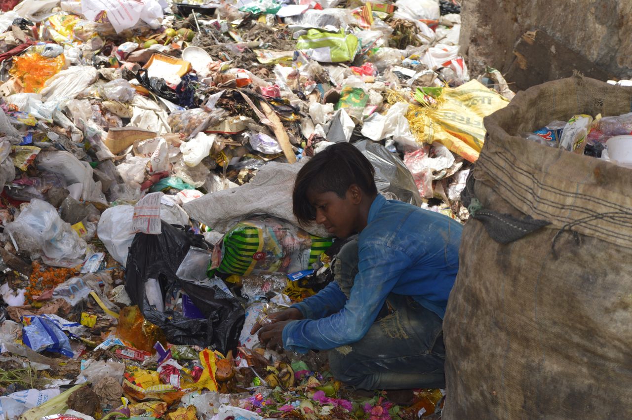 A wastepicker sorting through plastic waste in New Delhi. Much of India's recycling sector is informal.