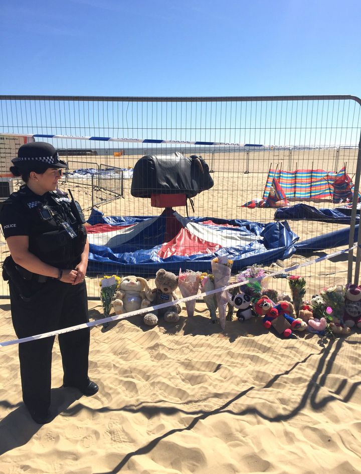 Floral tributes left at Gorleston beach in Norfolk where a girl was fatally thrown from an inflatable on Sunday.