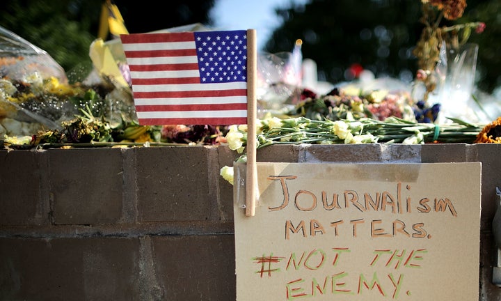 Flowers and hand-written notes were left by mourners at a makeshift memorial outside the Annapolis Capitol Gazette office for the five employees killed by a gunman last week.