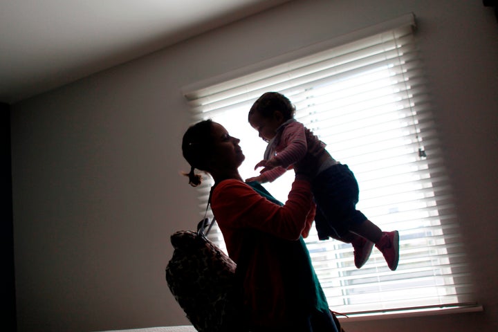 Deborah Oquendo, 42, carries her 10-month-old daughter, Genesis Rivera, at an Orlando, Florida, hotel on Dec. 1, 2017. They&n