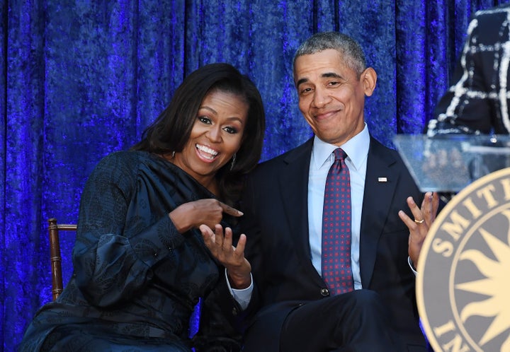 Former first lady Michelle Obama and former President Barack Obama react after their portraits were unveiled at the Smithsonian National Portrait Gallery on Feb. 12, 2018.