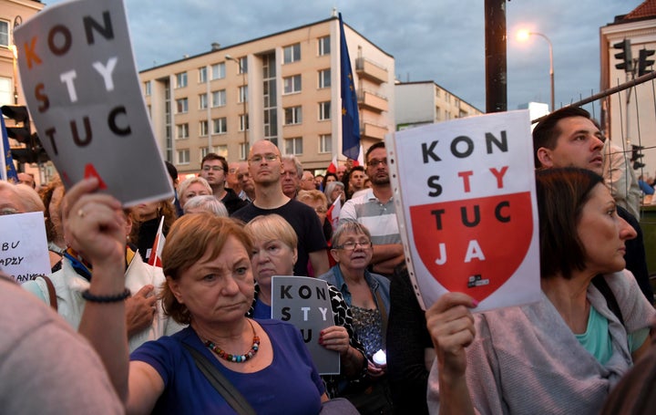 Protesters shout slogans and wave placards in support of the Supreme Court justices.