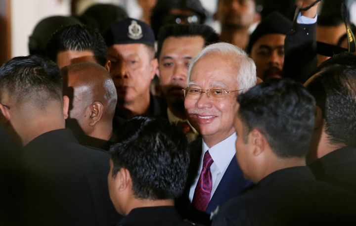 Former Malaysian prime minister Najib Razak reacts as he walks to a courtroom, after his arrival in court in Kuala Lumpur, Malaysia July 4, 2018.
