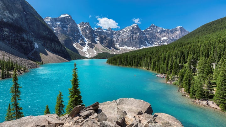 Banff National Park of Canada includes snow-covered peaks and Moraine Lake.