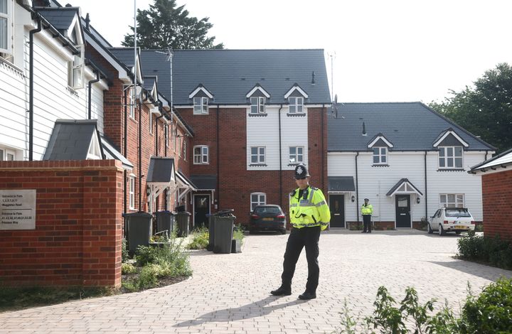 Police stand guard outside a block of flats on Muggleton Road in Amesbury where the couple were found unconscious on Saturday