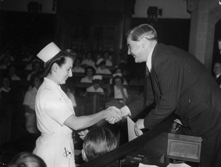 British Health Minister Aneurin Bevan presents a certificate to Nurse Johnson, one of the successful nurses of the County Nur