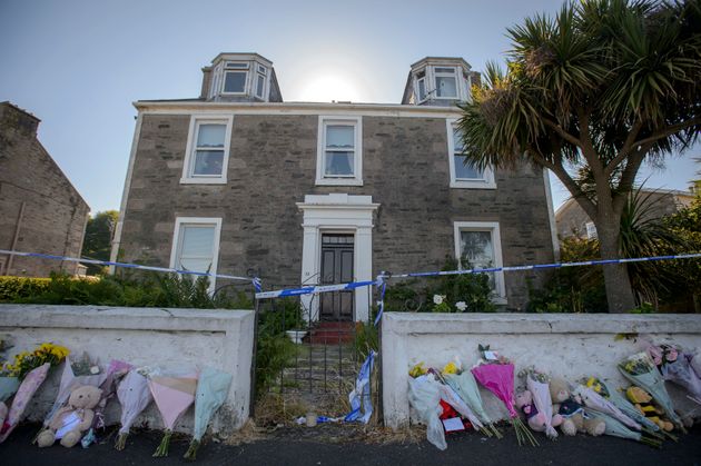 Police searching a house in Ardbeg Road on the Isle of Bute in Scotland.