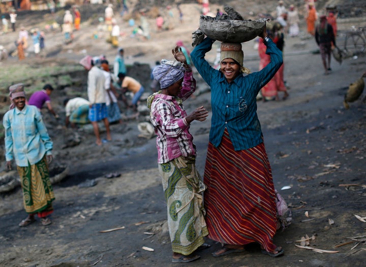 Women work at a dry pond on the outskirts of Kolkata, India, under the National Rural Employment Guarantee, an anti-poverty plan that provides 100 days of employment a year to tens of millions of rural poor people.