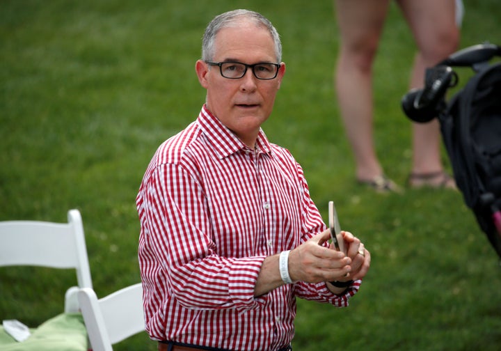 Environmental Protection Agency Administrator Scott Pruitt holds a mobile phone during a picnic for military families celebra