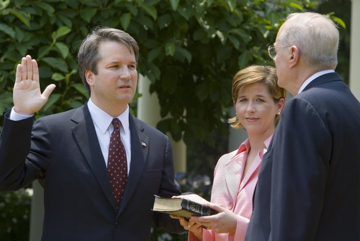 Brett Kavanaugh (L) is sworn in as a judge for the U.S. Court of Appeals for the District of Columbia Circuit by Supreme Court Justice Anthony Kennedy (R).