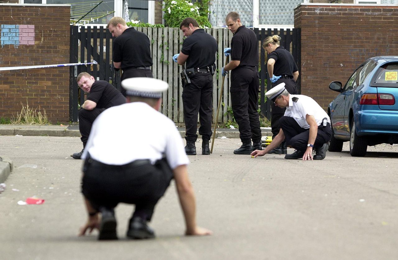 Police search teams in Aston, Birmingham, where a woman resident was shot as she watched two gangs clash in the street outside her home