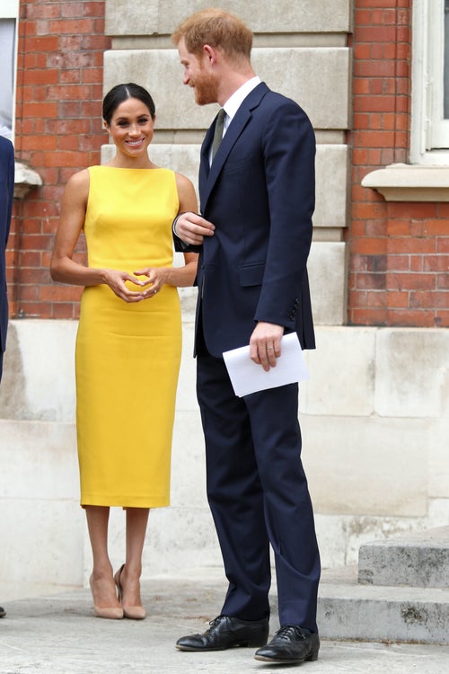 blue suit yellow dress Meghan Markle Can't Stop Wearing The Same Style Of Dress