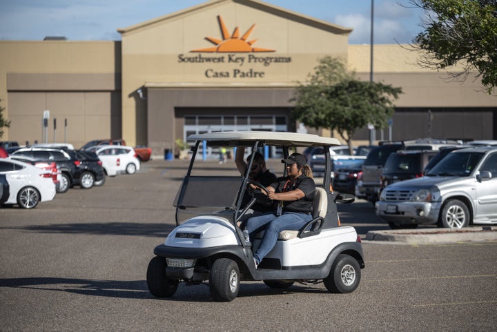 Security guards monitor the perimeter of the Southwest Key-Casa Padre Facility, formerly a Walmart store, in Brownsville, Tex