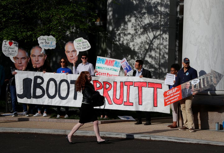 People protest before EPA Administrator Scott Pruitt testifies before a House Energy and Commerce Subcommittee hearing in April.