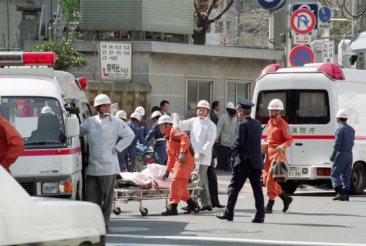 This picture taken on March 20, 1995, shows a victim on a stretcher being moved to an ambulance at Tsukiji subway station fol