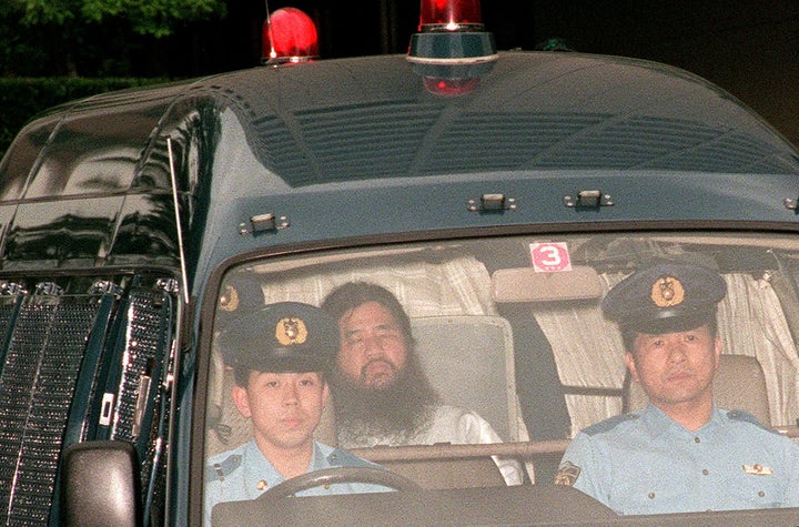 In this picture taken on July 19, 1995, Shoko Asahara (C), head of the doomsday cult Aum Shinrikyo, is transferred from Tokyo
