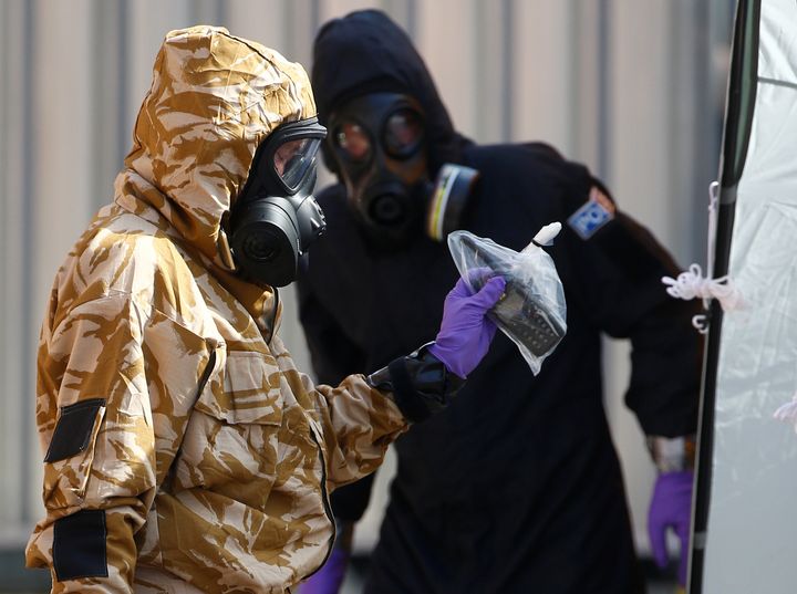 Forensic investigators, wearing protective suits, emerge from the rear of John Baker House, after it was confirmed that two people had been poisoned with the nerve-agent Novichok, in Amesbury.