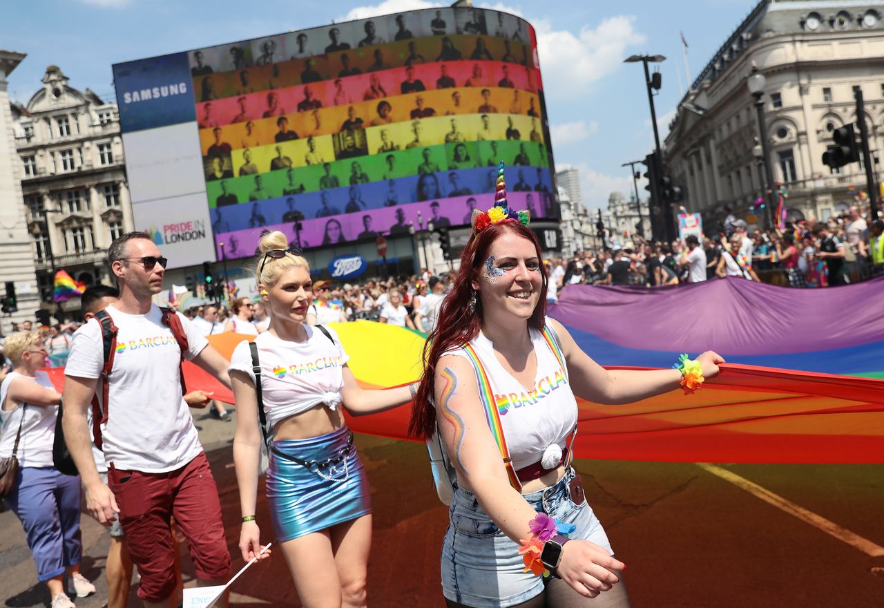 Parade goers at Piccadilly Circus during Pride In London