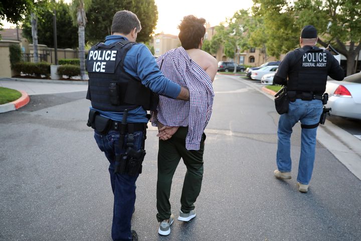 Immigration and Customs Enforcement assistant Field Office Director Jorge Field (left), 53, arrests an Iranian immigrant in San Clemente, California.