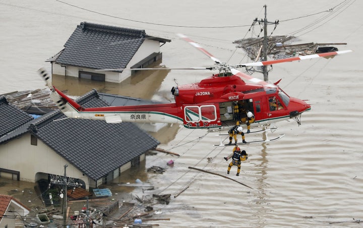 Local resident rescued by helicopter from a submerged house in Kurashiki on July 7, 2018.