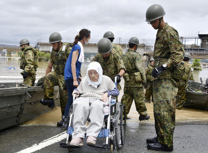 An elderly man in a wheelchair rescued from a flooded area in Kurashiki on July 8, 2018. 