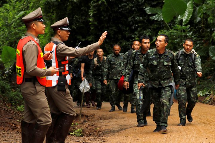 Soldiers arrive outside the Tham Luang cave complex, where 12 schoolboys and their soccer coach are trapped inside a flooded cave, in the northern province of Chiang Rai, Thailand.