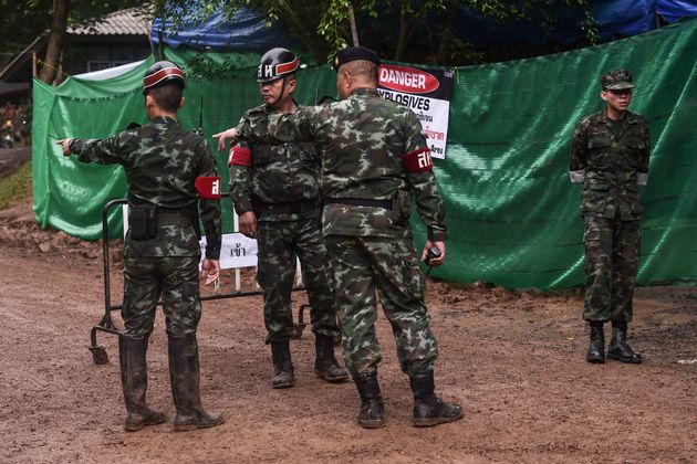 Thai soldiers speak at the Tham Luang cave area as operations continue for the 12 boys and their coach trapped at the cave in Khun Nam Nang Non Forest Park in the Mae Sai district of Chiang Rai province.